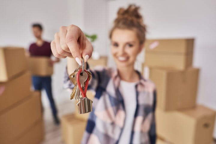 Woman s hand showing keys from new apartment